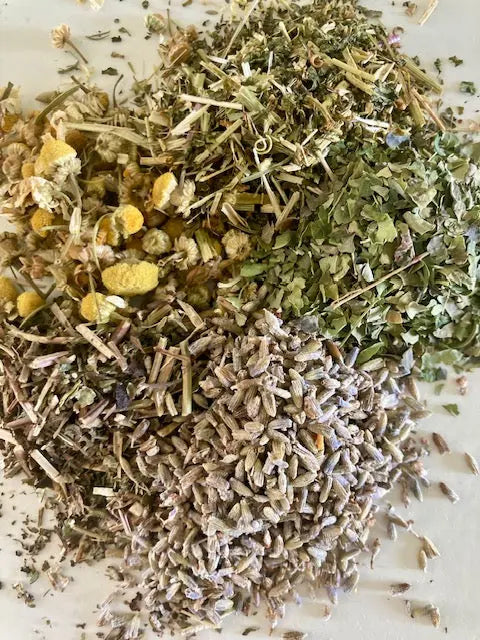 Mixture of dried herbs and flowers on a white surface